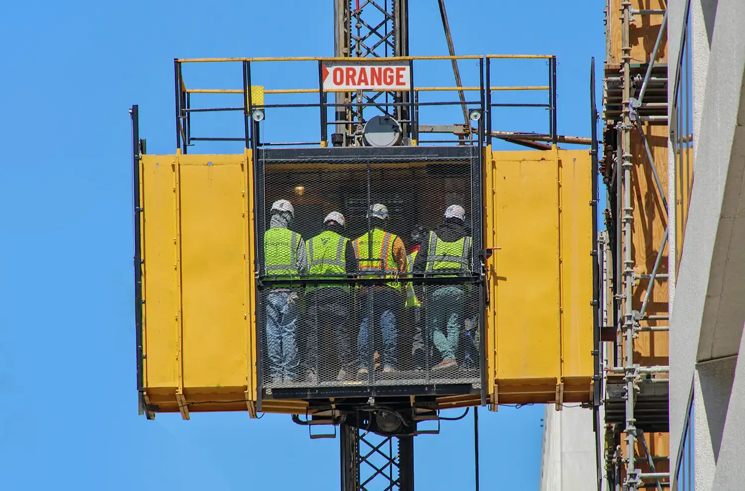  Passenger hoist transporting workers and material on site